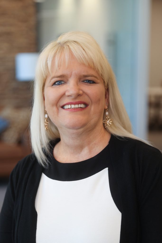 blonde woman in black and white blouse
